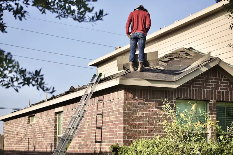 Professional roofer working on a residential roof in Pecos Vistas